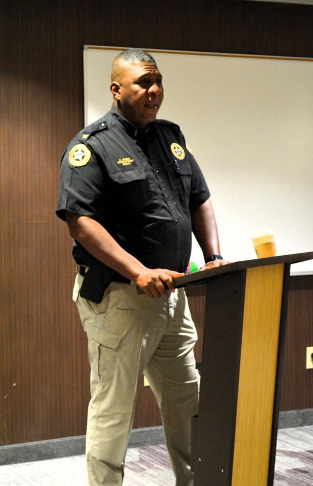Assistant Chief Deputy Kirby Dawson speaking to students from a podium at a Polished, Poised, and Prepared for Success workshop